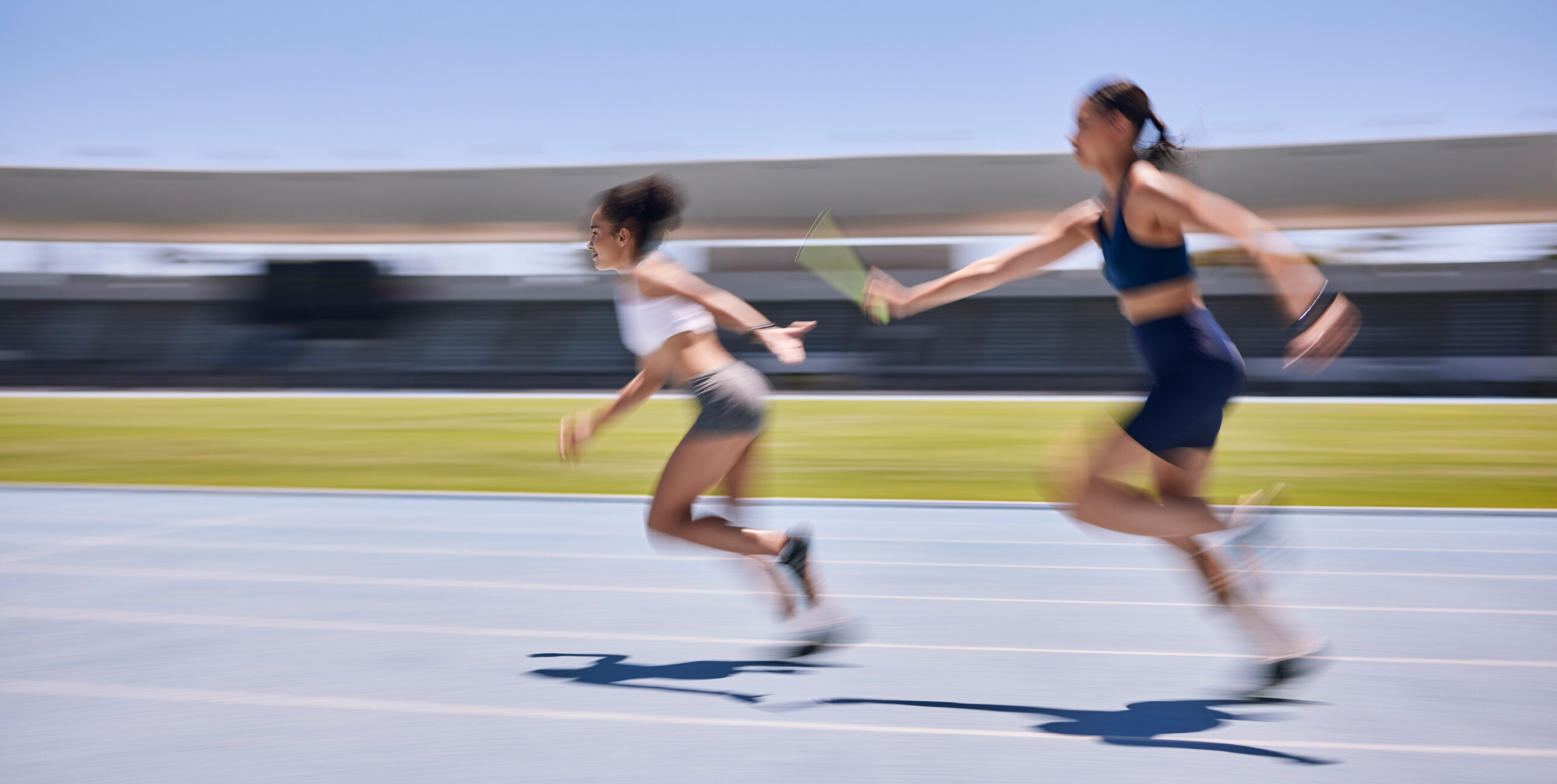 Relay race, running and sports women at a stadium for training, energy and workout. Sport, runner a.